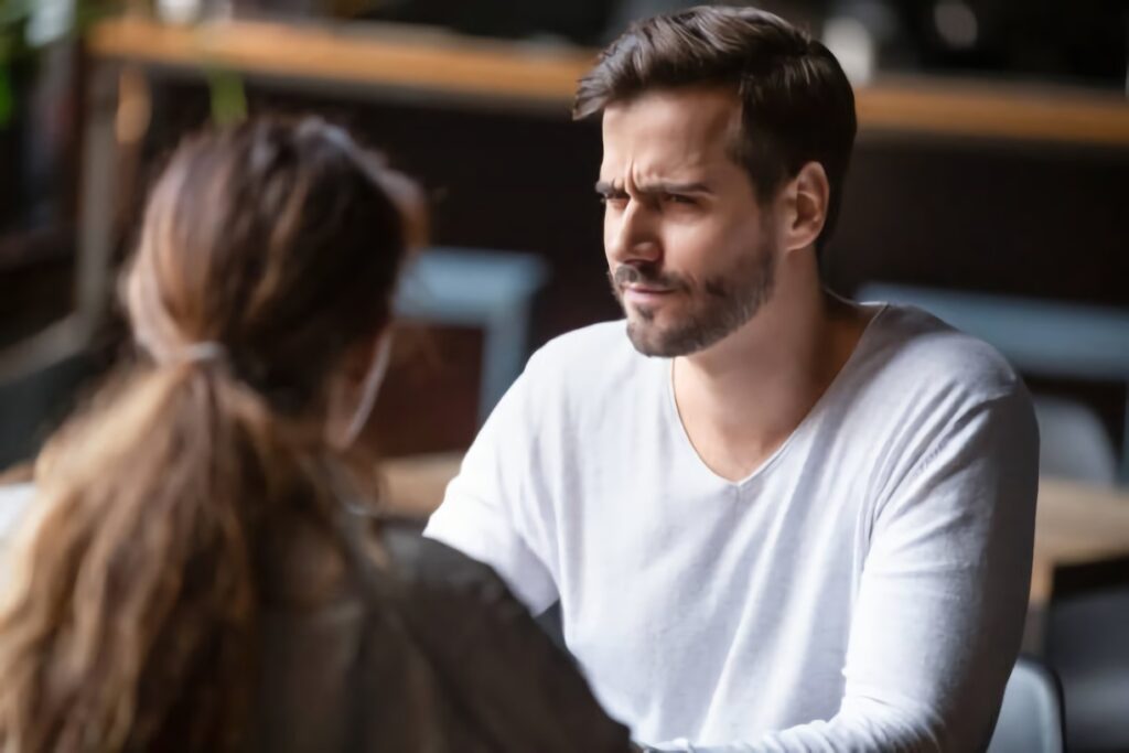 A man listening to a woman