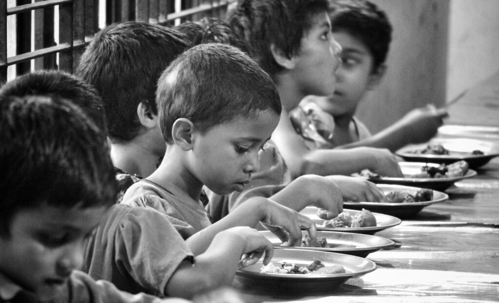 orphans eating on a table