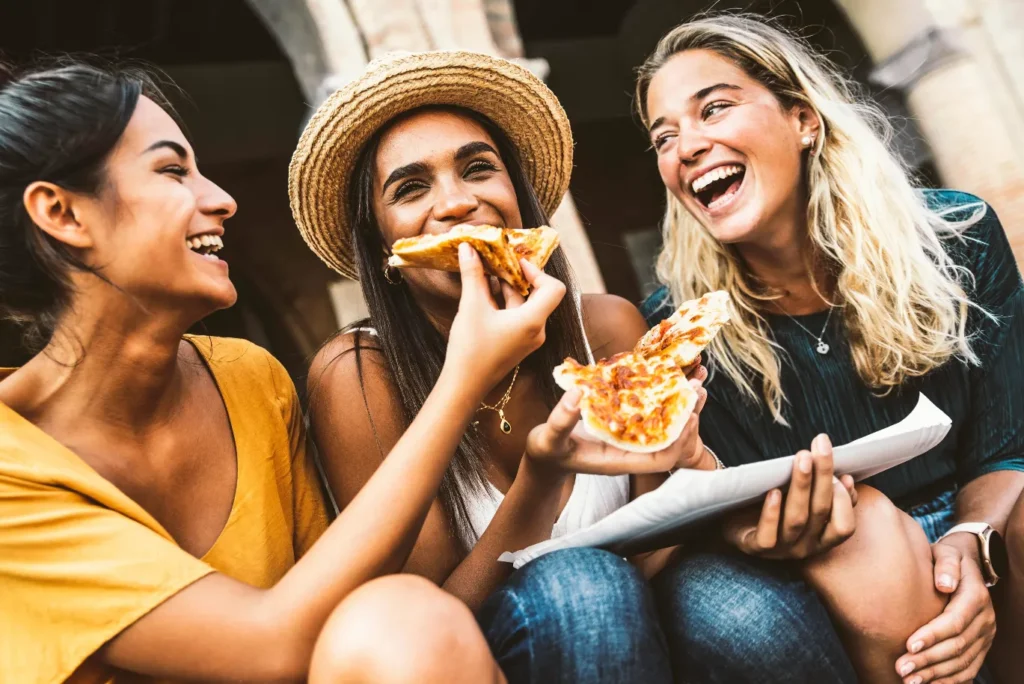 A group of happy friends eating street food